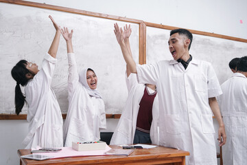 Asian Man Teacher And Students Wear White Lab Coat Raising Hands Celebrating Achievement Inside...
