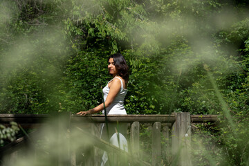 Latin woman taking a walk in nature in a white dress. Mindfulness in nature
