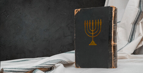 Old book Talmud, Hebrew Rabbinic Judaism, Jewish religious law. Torah, Hebrew Bible. Menorah on a...