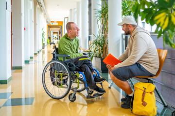 Man with disability talking with a friend in the university