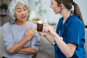 young caregiver assists her elderly woman patient at a nursing home. senior woman is assisted by a nurse at home.