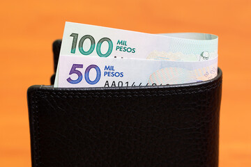 Colombian peso in the black wallet