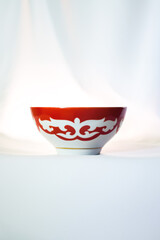 Kazakh piala. Central Asia traditional tea cup with national ornament. National red bowl isolated on white background