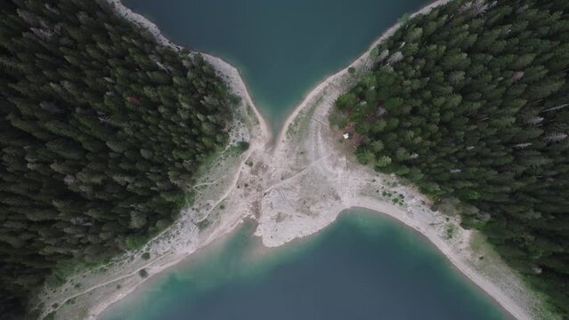 Aerial video, Crno Jezero or Black Lake, pine forest and cliffs in Dormitor National Park, Zabljak