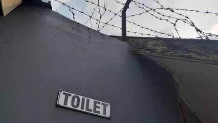 Public toilet sign on the wall