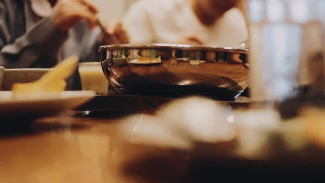 Different colorful meals for breakfast or lunch time on a plate with cutlery on woman's hands. Fried eggs, omelette, bruschetta and sausage on a wooden teble in restaurant. Flat lay top view.
