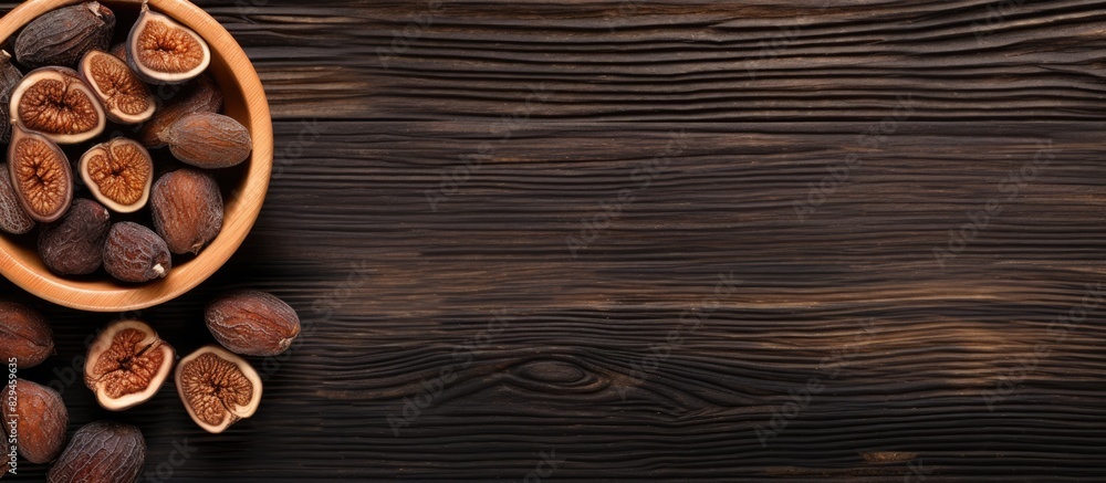 Aufkleber bowl with tasty dried figs on wooden table top view space for text. copy space available