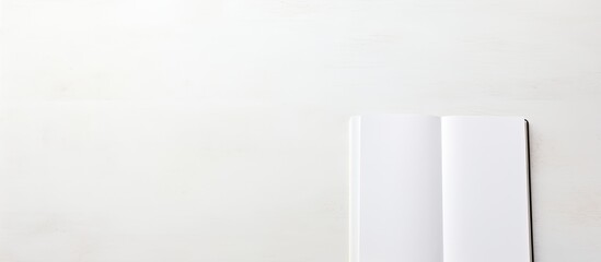Notebook on white table. copy space available