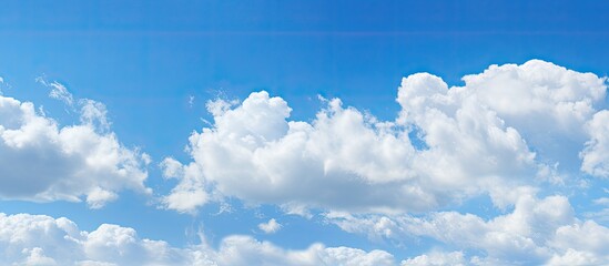 During daylight hours a stunning blue sky acts as the canvas for a breathtakingly beautiful image featuring wispy white clouds Ideal for both background and copy space