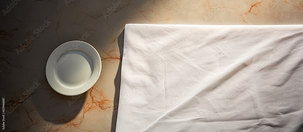 Poster copy space image of a white marble desk with a napkin on it against a wall background with shadows p