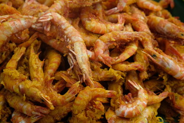 Delicious fried sea prawns on a container. Shrimp or prawns is a variety of seafood. Indonesian...