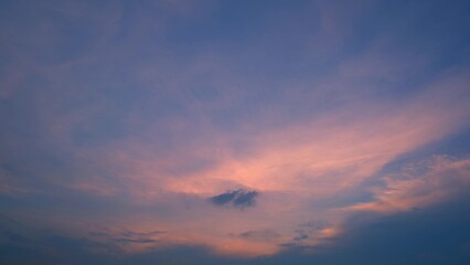 A beautiful evening sky painted with soft hues of pink and purple. The clouds are spread out,...