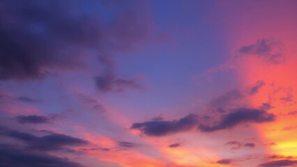A stunning sunset sky with a gradient of colors transitioning from deep blue to vibrant pink and...