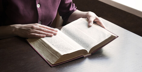 Woman's hands holding a bible