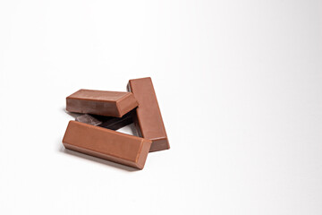 chocolate pieces on white,Milk chocolate pieces isolated on white background, chocolate pieces, cocoa dessert slices