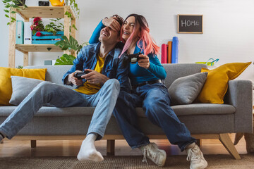 Friends having fun and playing video game at home