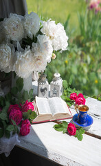 Book and coffee near a bouquet of flowers