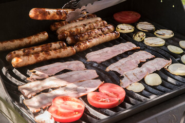 Barbecue stocked with English breakfast items closeup