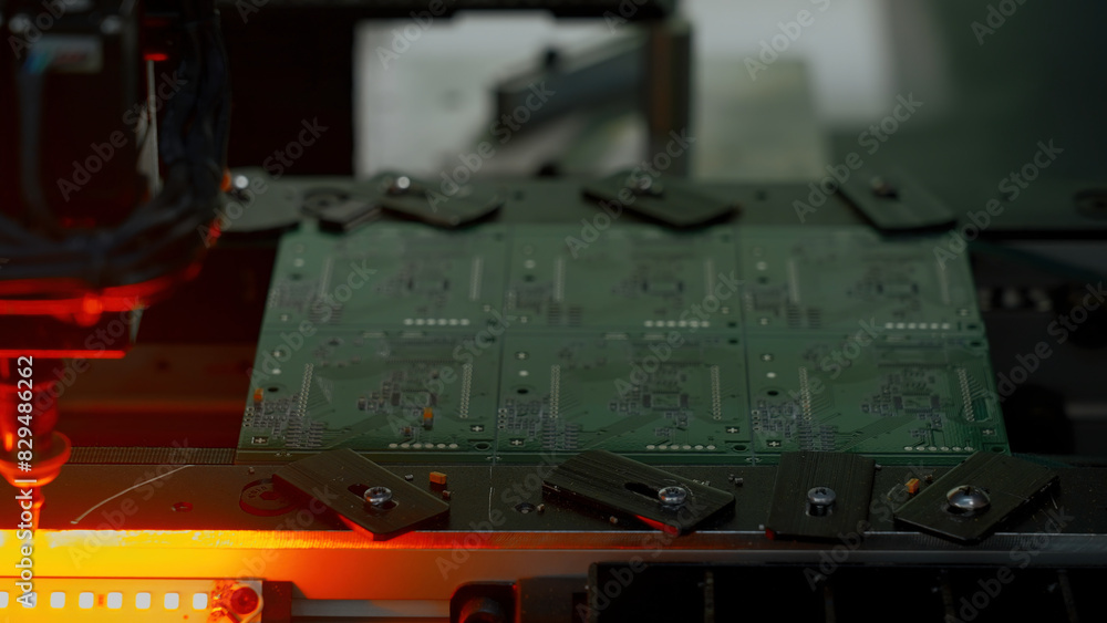 Poster coating machine for printed circuit board at work. creative. close up of automated robotic mechanism