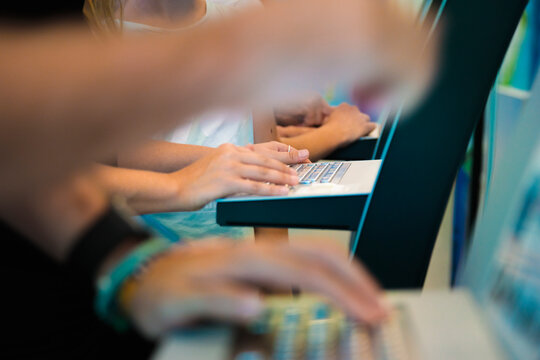 Hands of man and woman doing self-service check-in at indoor skydiving center