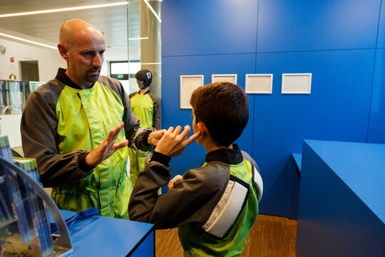 Father explaining rules to boy at indoor skydiving center