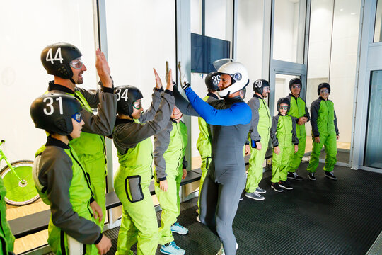 Instructor cheering people at indoor skydiving center