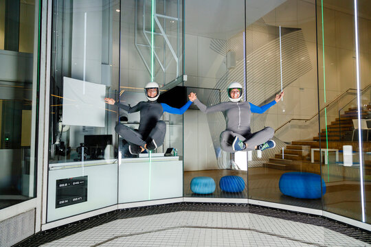 Instructors practicing and levitating at indoor skydiving center