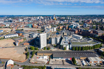 Obraz premium Aerial photo of the Leeds City Centre showing the area in Leeds knows as the Docks on a sunny summers day with the Clarence House apartments over looking the whole of of the city of Leeds