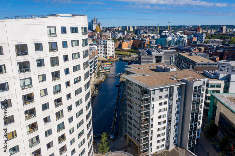 Wall mural Aerial photo of the Leeds City Centre showing the area in Leeds knows as the Docks with canal barges in the canal on a sunny summers day and the Clarence House apartments