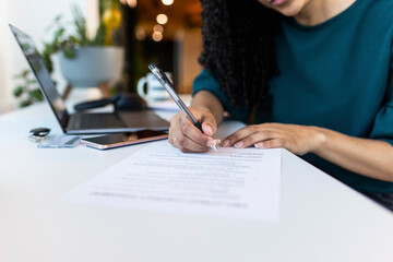 Recruiter filling employee form with pen at office