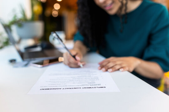 HR recruiter filling employee form at desk in office