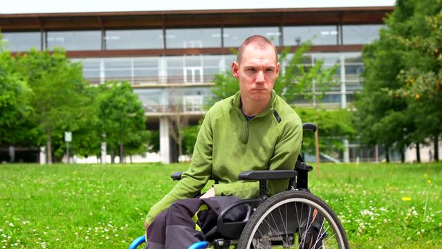 Man with disability sitting in an electric wheelchair in the university campus