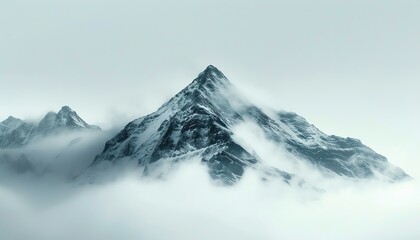 Majestic snow-capped mountain peak emerging through the clouds on a foggy day, showcasing the serene, natural beauty of winter landscapes.