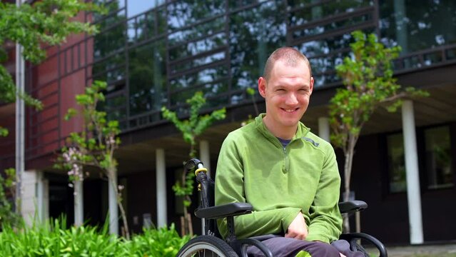 Close-up portrait of a proud man with cerebral palsy in the university campus looking up