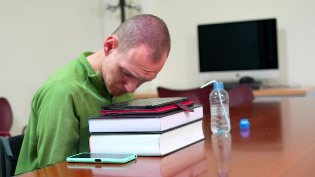 Man with disability sitting in wheelchair in the study room of the university