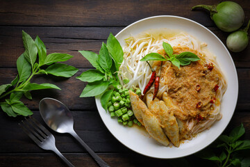 Rice noodles in fish curry sauce with vegetables ,Noodles with fish chili paste. Traditional Thai food Vermicelli served with vegetables isolated on white background, original food concept.