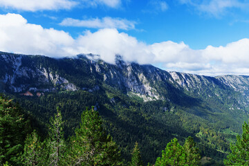 Obraz premium Amazing mountain views in summer. Mountain peaks in the clouds.