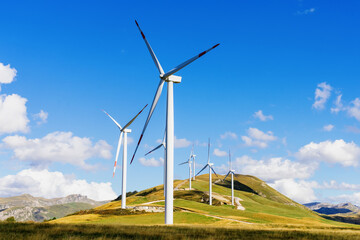 Wind renewable energy. Windmills in the highlands. Production of electric energy.