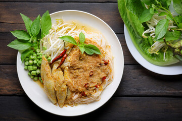 Rice noodles in fish curry sauce with vegetables ,Noodles with fish chili paste. Traditional Thai food Vermicelli served with vegetables isolated on white background, original food concept.