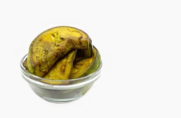 Oil Fry Eggplant or Brinjal Slices in a Glass Bowl Isolated on White Background with Copy Space