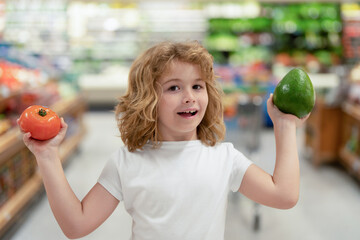 Child in food shop in food market store. Kids shopping in food shop supermarket. Sales, shop and...