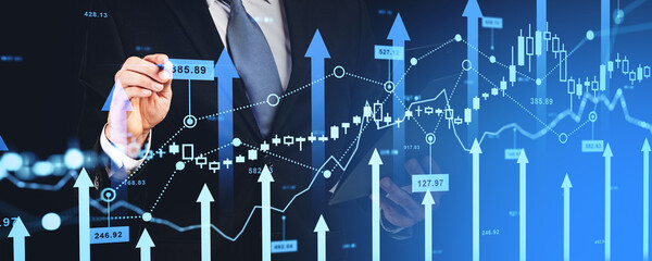 Businessman pen touch forex diagrams and stock market data with lines