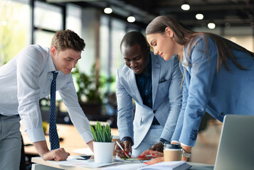 startup business team on meeting in modern bright office interior brainstorming, working on laptop and tablet computer