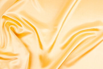 Elegant golfen silk fabric background with waves.