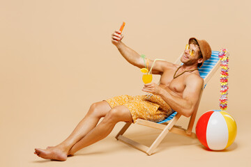 Full body young man wear yellow shorts swimsuit relax rest near hotel pool sit in deckchair do...