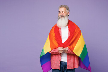 Happy shocked elderly bearded gay man 50s year old wears casual clothes wrapped in striped rainbow...