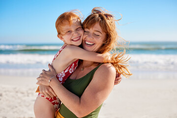 Mother and daughter with red hair having fun at beach while hugging