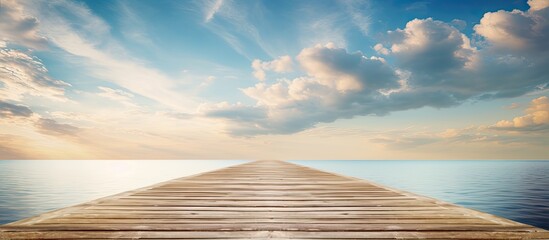 An elegant wooden pier extending into the horizon with a picturesque sky and clouds creating a serene and tranquil atmosphere with copy space image - Powered by Adobe