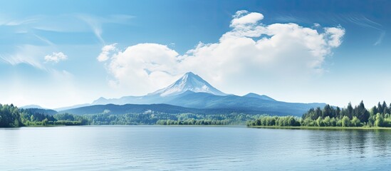 Fototapeta premium Scenic landscape with a mountain lake forest and clear blue sky ideal for a copy space image