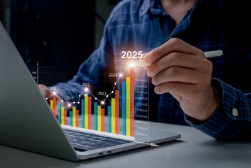 Business growth year 2024 to 2025. Businessman analyzes profitability of working companies with...